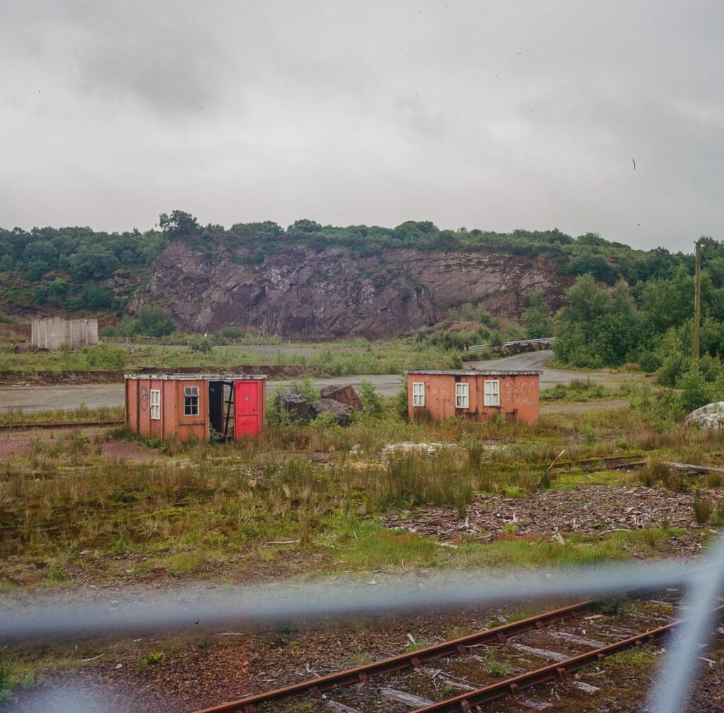 Small metal structures beside train tracks