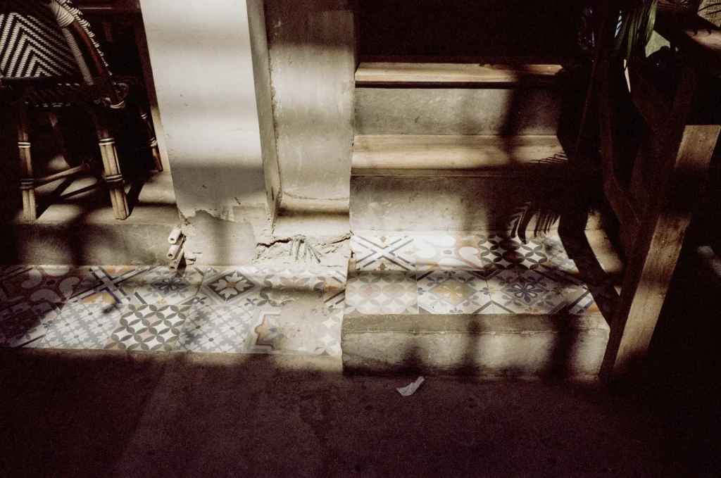 A shadowy pattern overlays an ornately-decorated stairwell.