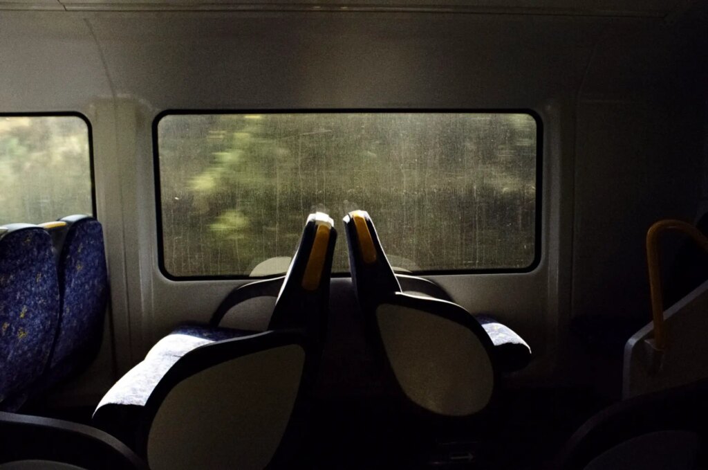 Train seats back to back on a rainy gloomy day