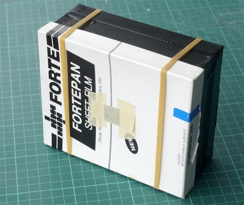 Film box pinhole camera showing pinhole 'tape shutter'.