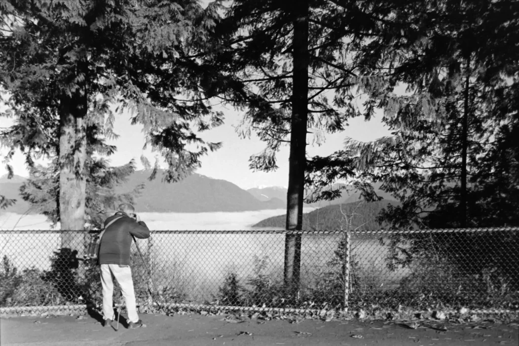 Man taking picture of Clouds over Inlet