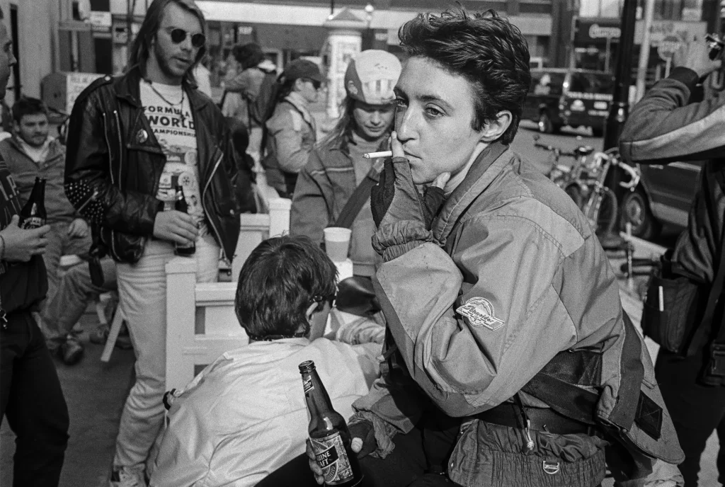 female messenger with cigarette in crowd