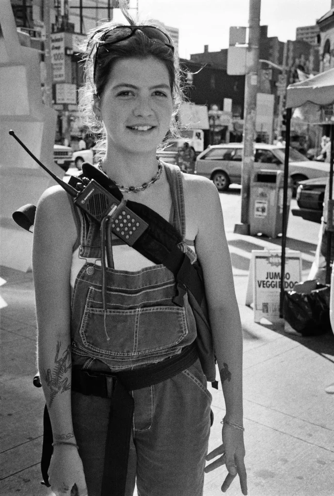 female messenger standing on corner