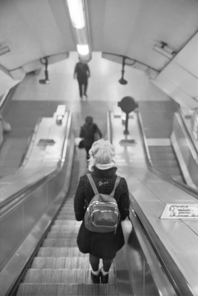 Escalator Riders Ilford HP5+ Olympus 35SP