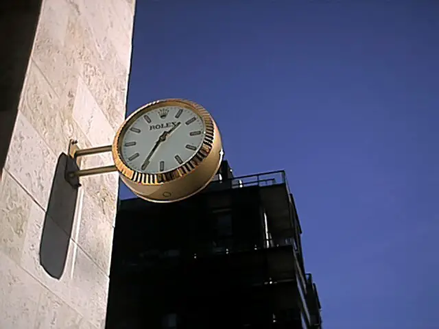 An advertising clock in the front wall of a Rolex store