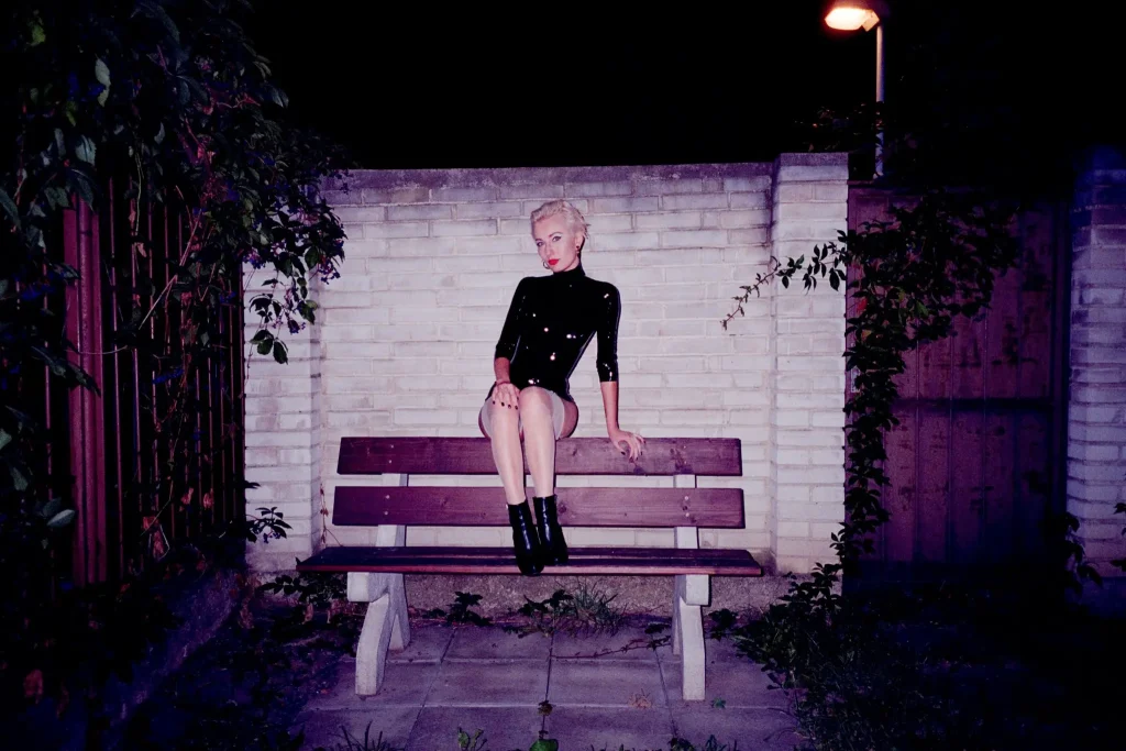 Portrait of young woman sitting on bench made with the Minolta TC-1