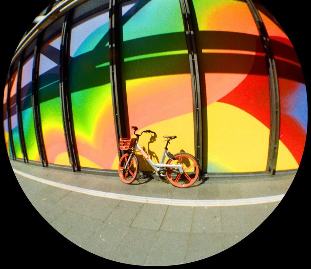 bike propped against colorful wall