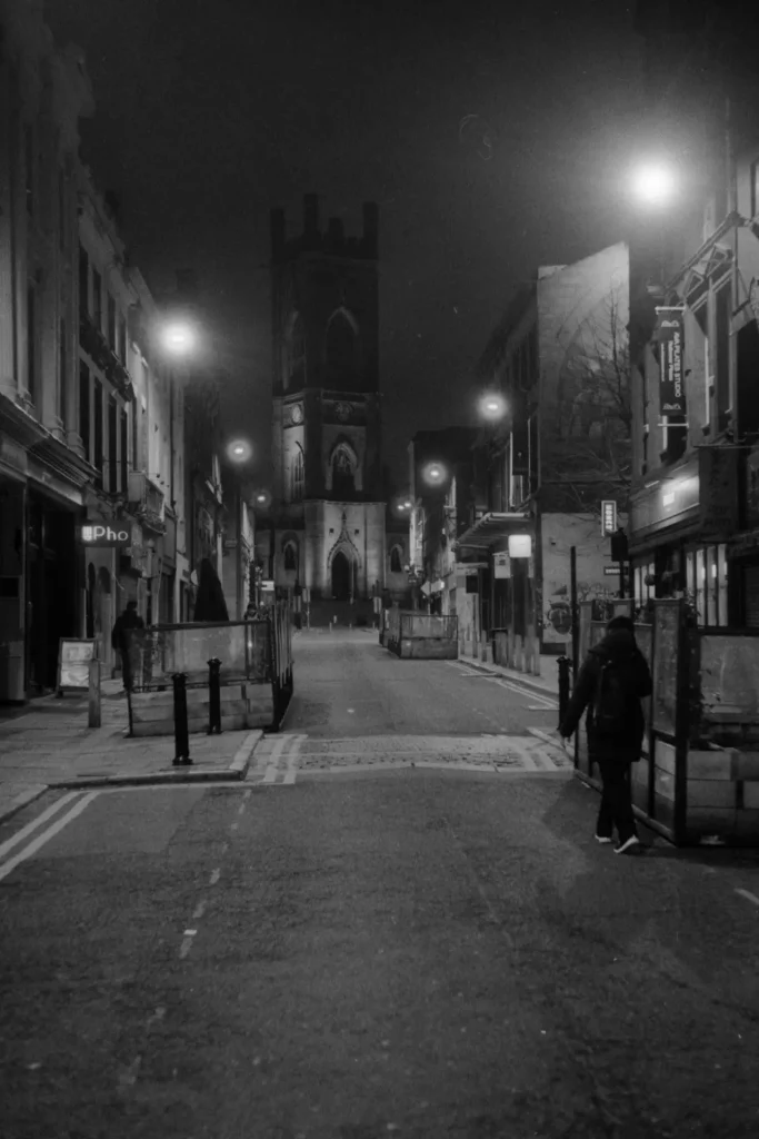 A street scene with a church in the background.