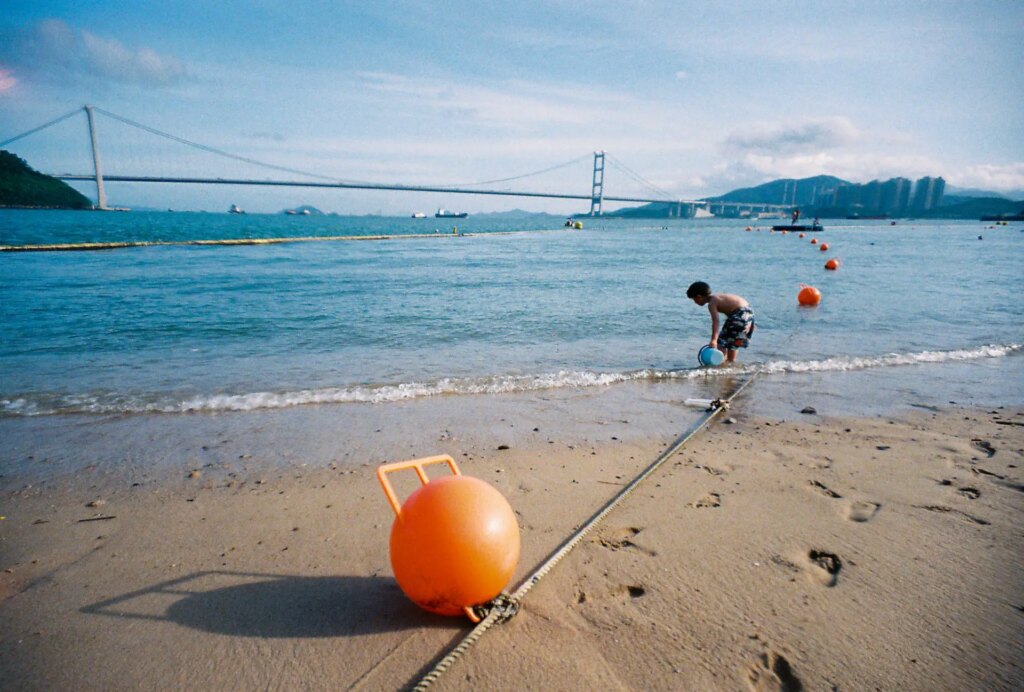 beach scene with bridge in background