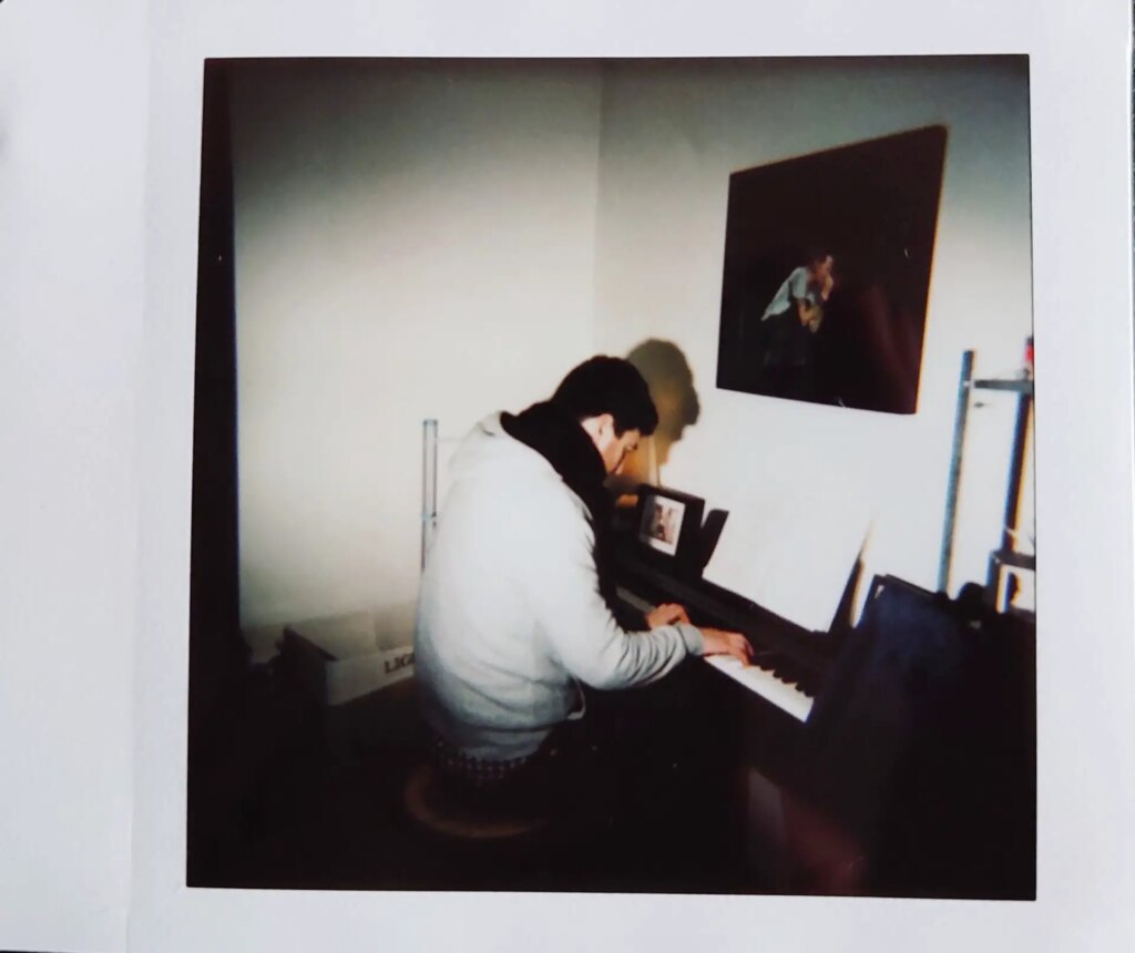 man playing piano on instax square film