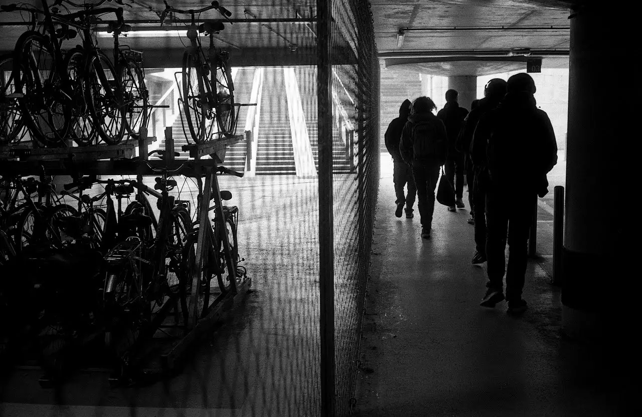 People walking by underground bike parking in Leuven, Belgium