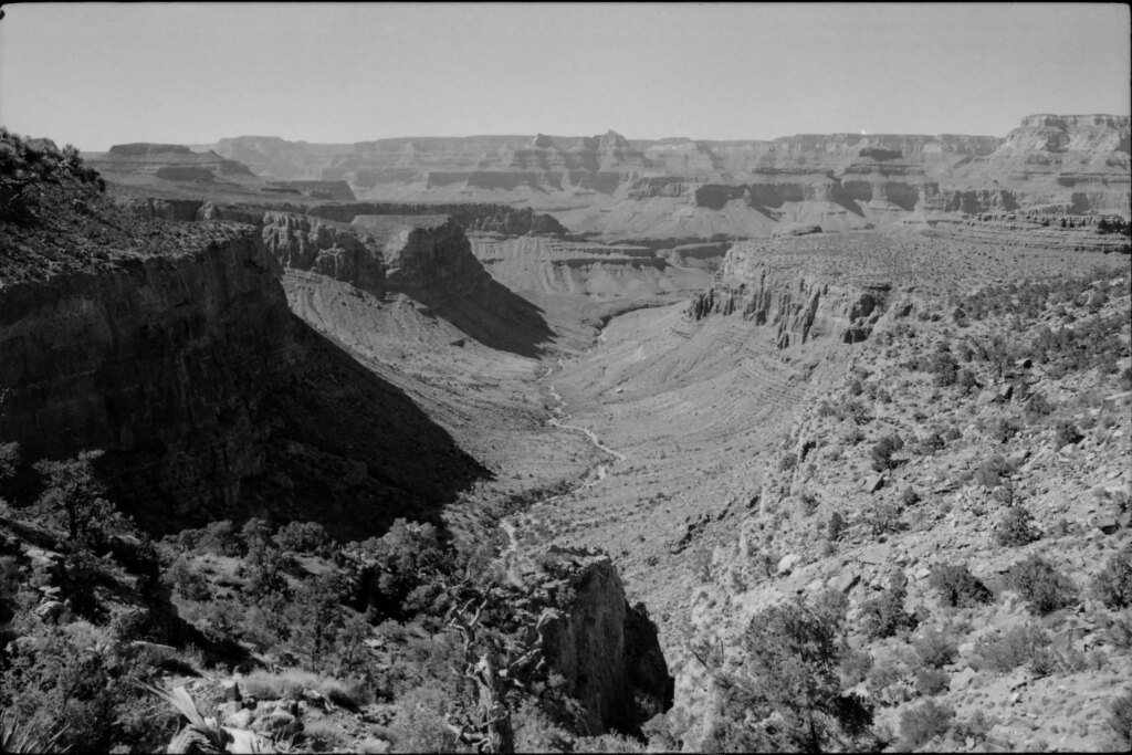 black and white photograph during midday looking north across the grand canyon