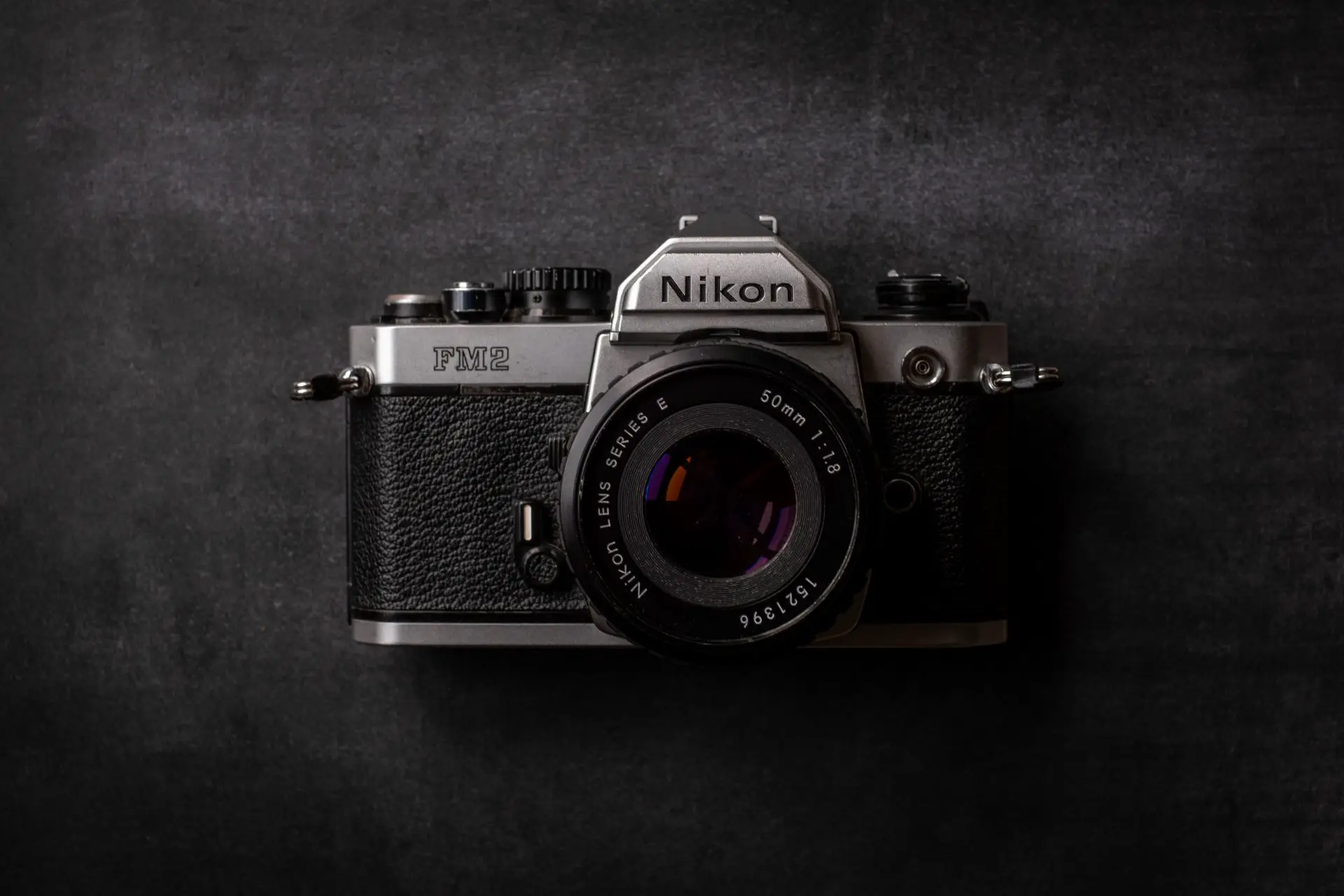 A Nikon FM2 against a black background.