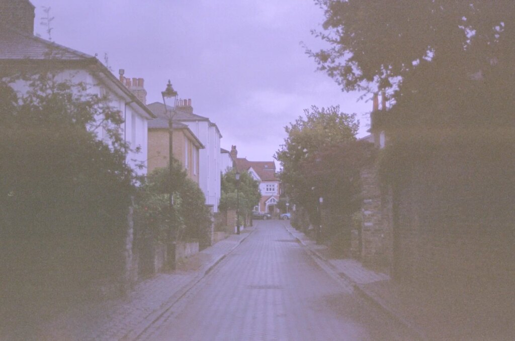 A road with a building at the end of it.