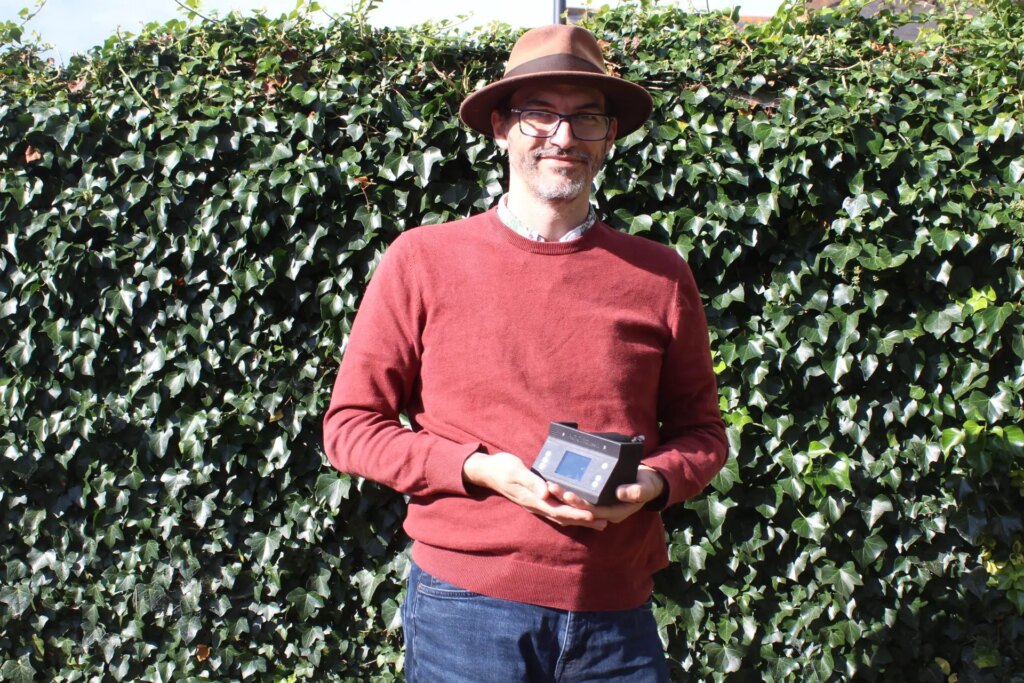 Dave Walker holding an Ago film processor