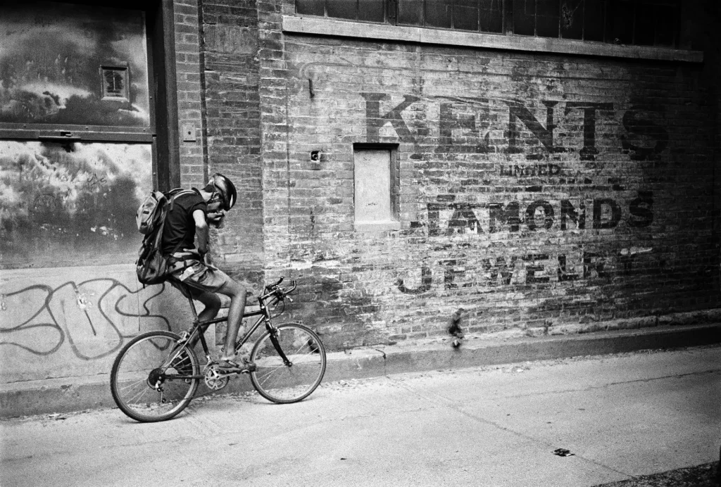 tired messenger leaning against wall