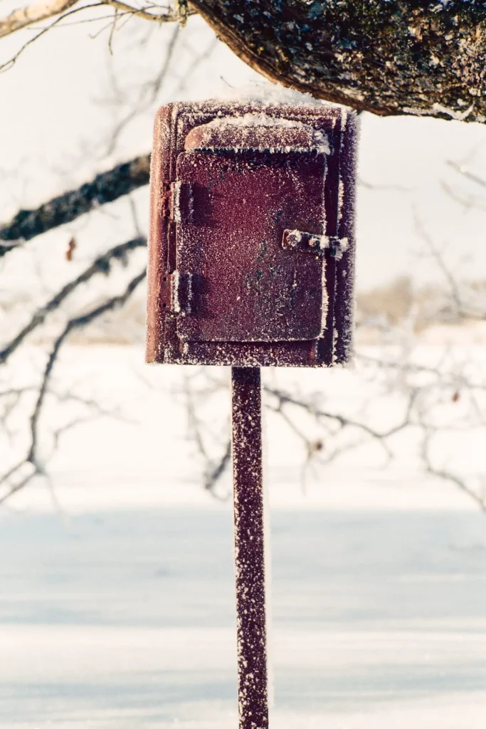 Photo of a post box in winter shot on slide film.
