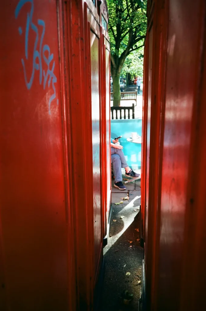 Red phone boxes street photo