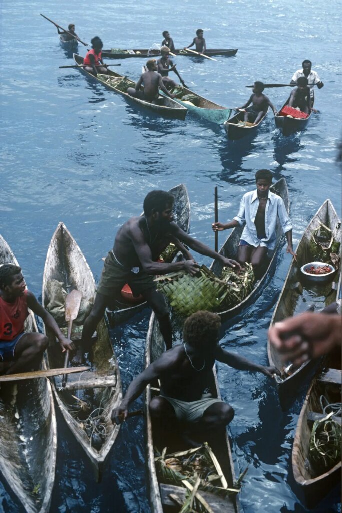3 Dai Islanders selling fresh and cooked food to travellers on a ship (including yours truly) en-route to Ontong Java and Sikaiana. Malaita Province, Solomon Islands. Olympus OM40, 50mm lens. 1989.