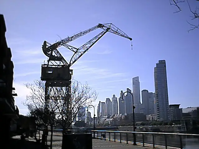 Old harbor cranes, and distant skyscrapers of Puerto Madero