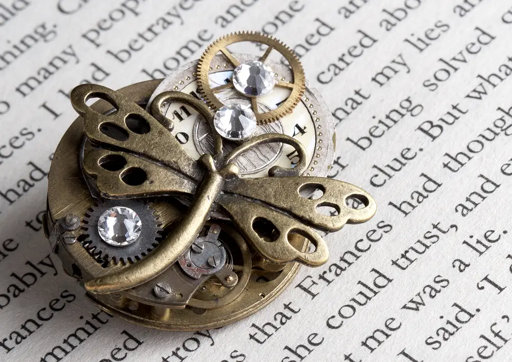 steampunk dragonfly broach on book