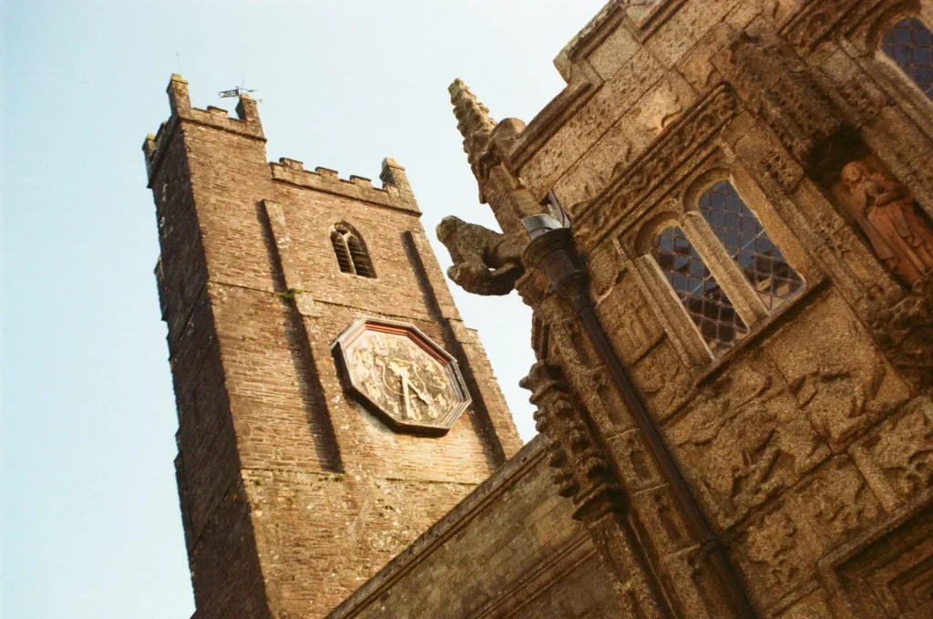 Carved granite church wall and clock tower