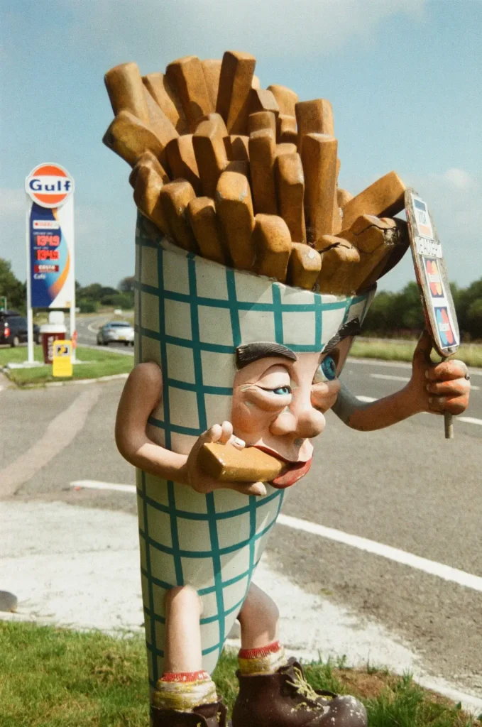 Characterful mascot-type figure outside service station