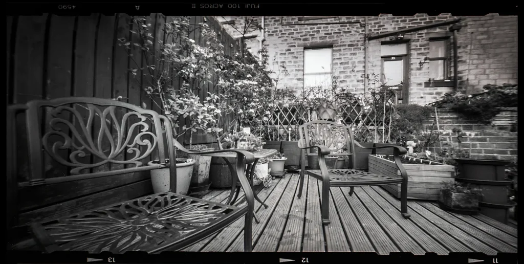 Low viewpoint of a decked back yard in black and white
