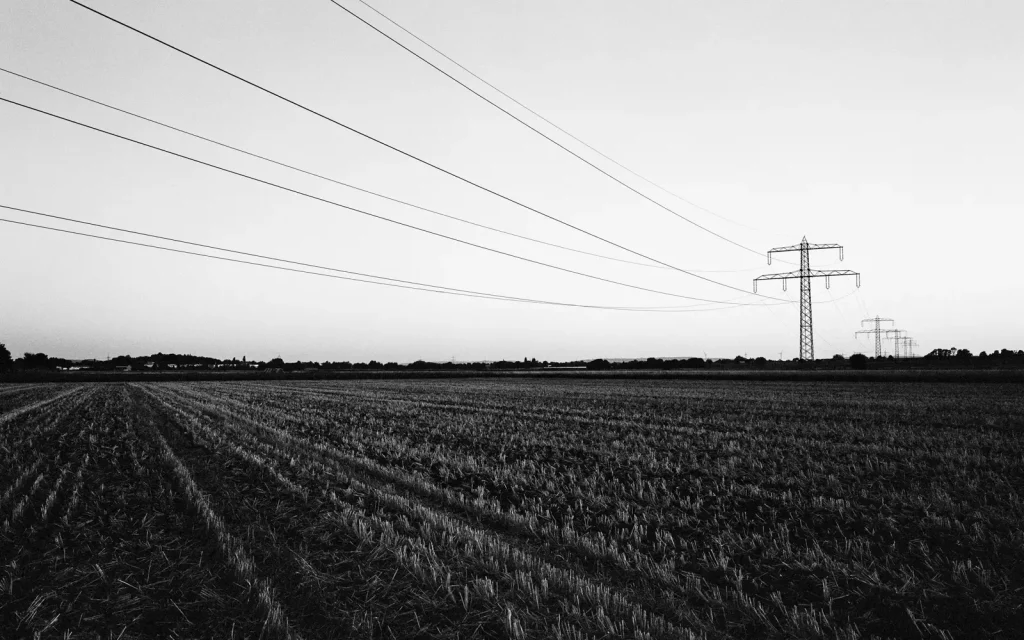 Agricultural landscape close to the village Ingeln-Oesselse in northern Germany: power poles standing on harvested fields