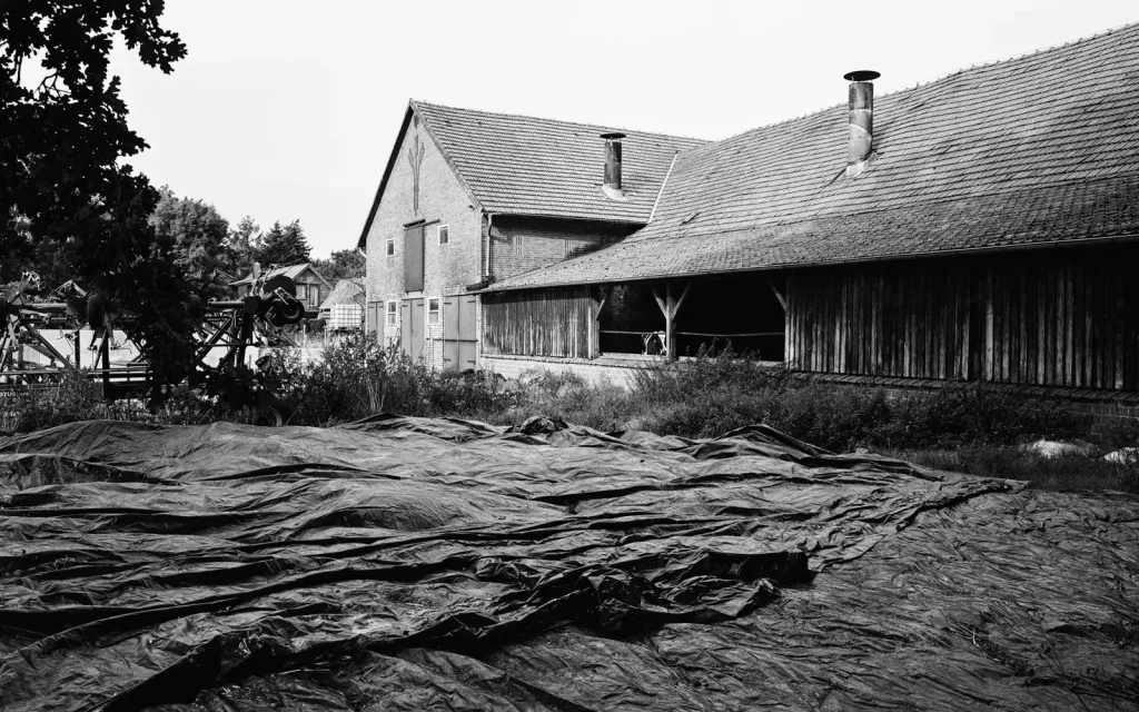 farm house with tarps spread out in the foreground