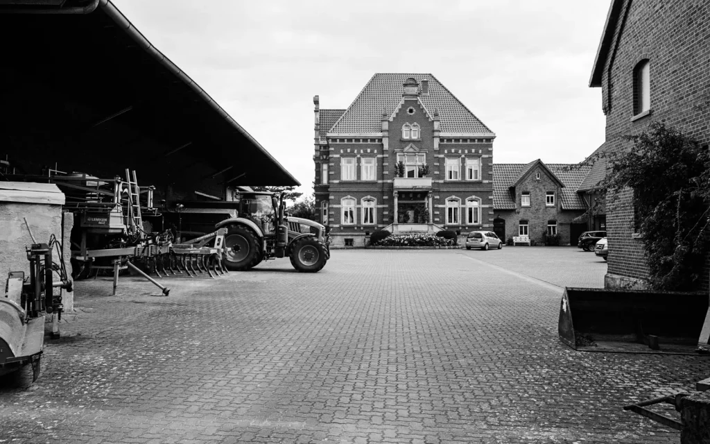 farmyard with a stately residence in the center