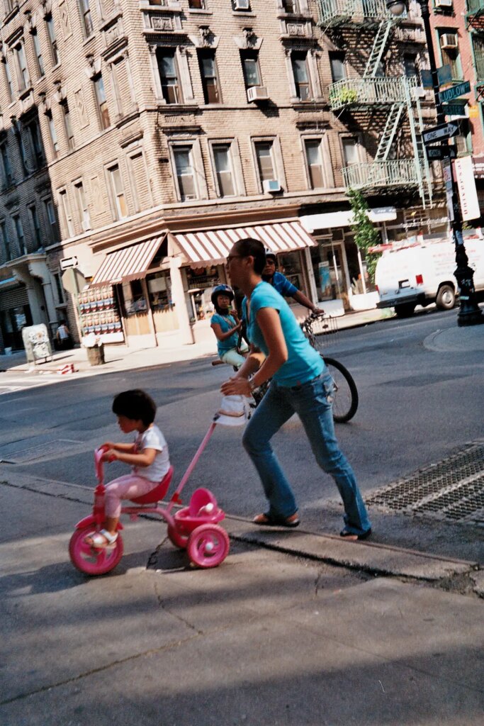 women pushing daughter on a bike