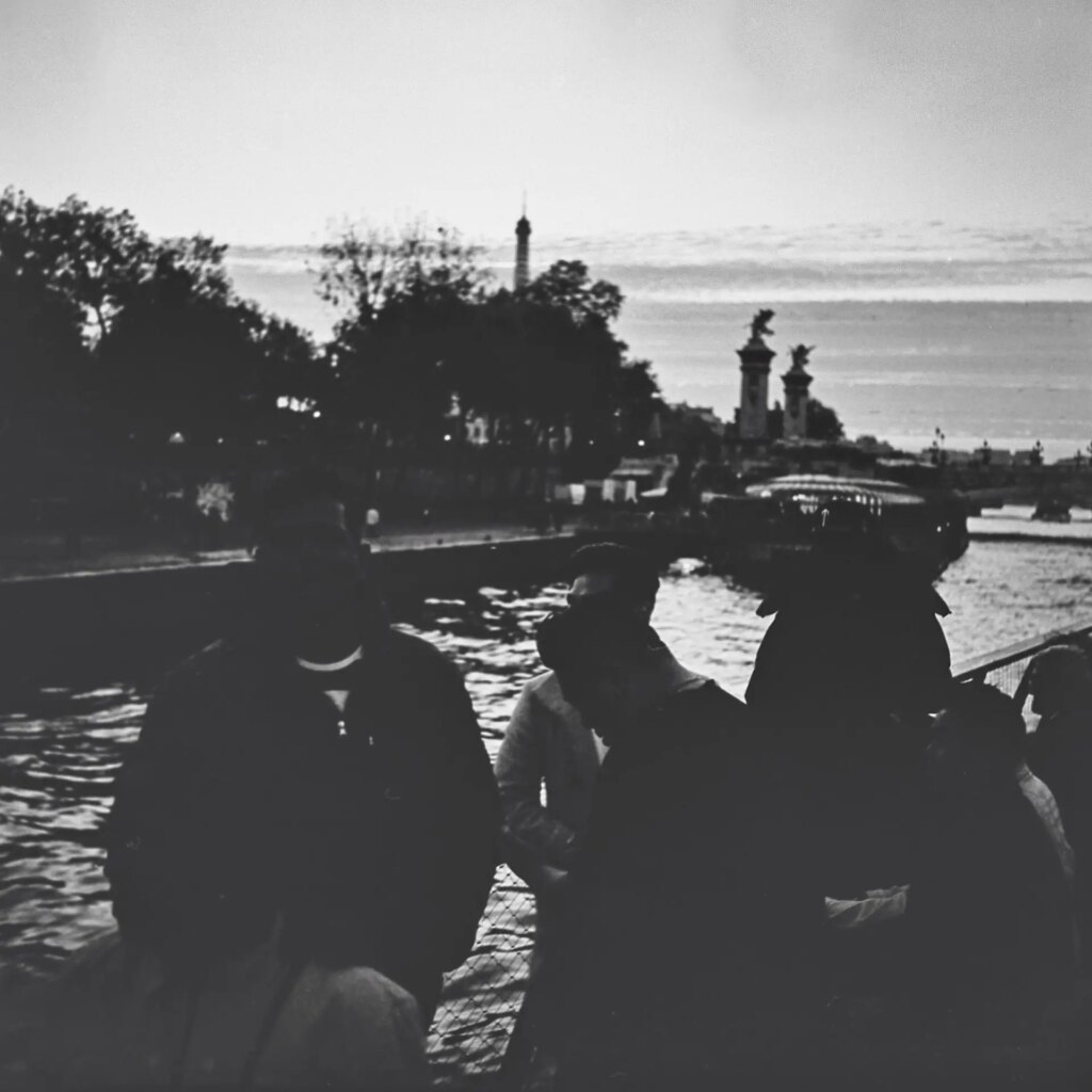 dark black and white image of people on a boat
