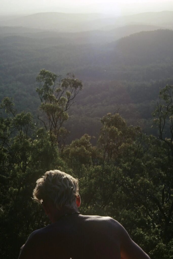 4 My brother, Owen, backlit by late afternoon sun, overlooking a state forest near Mt Crosby, in Yuggera Country, west of Brisbane, Queensland. There is some obvious flare in this image. Olympus OM40, 50mm lens. 1989. 