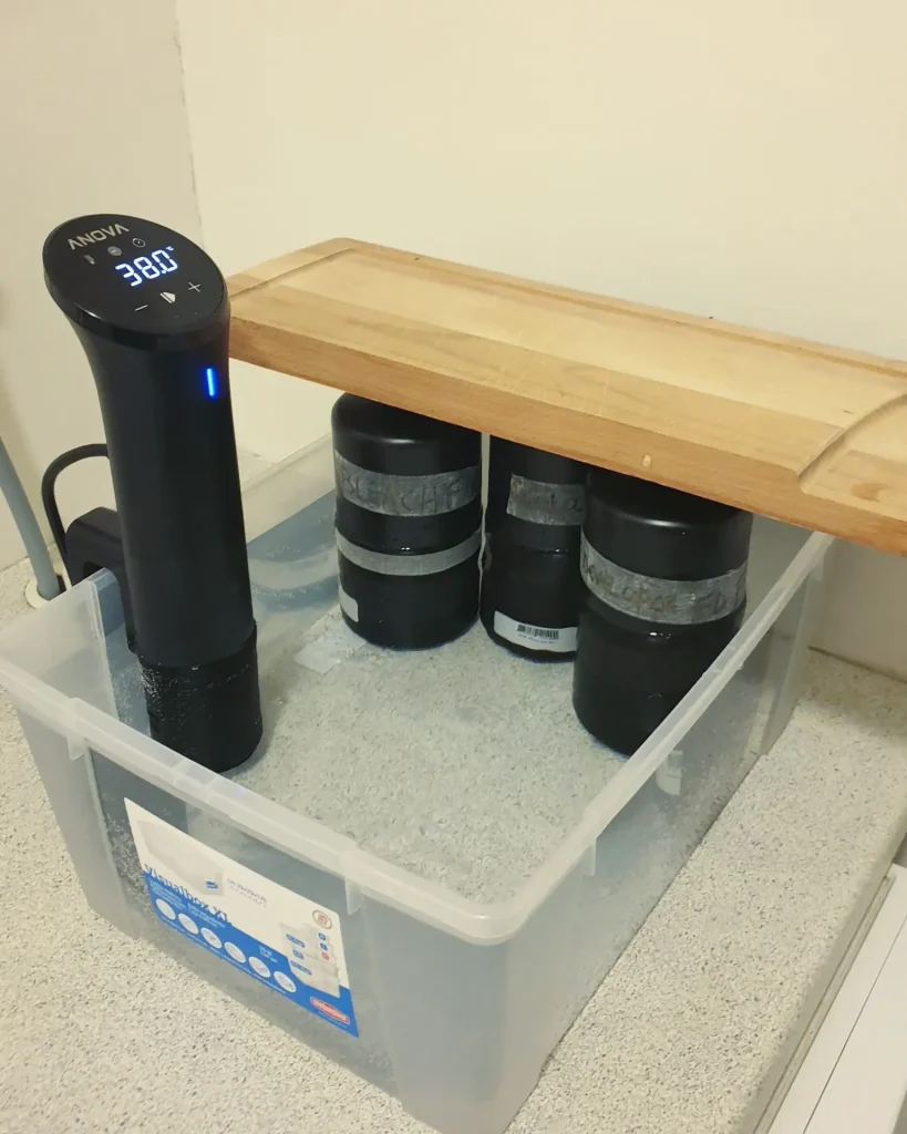 chopping board holding down bottles and sous vide