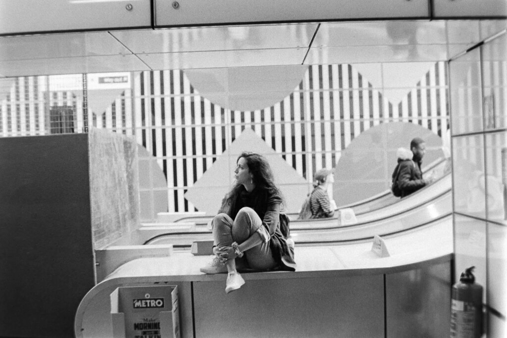 A lady waiting at an Underground Station