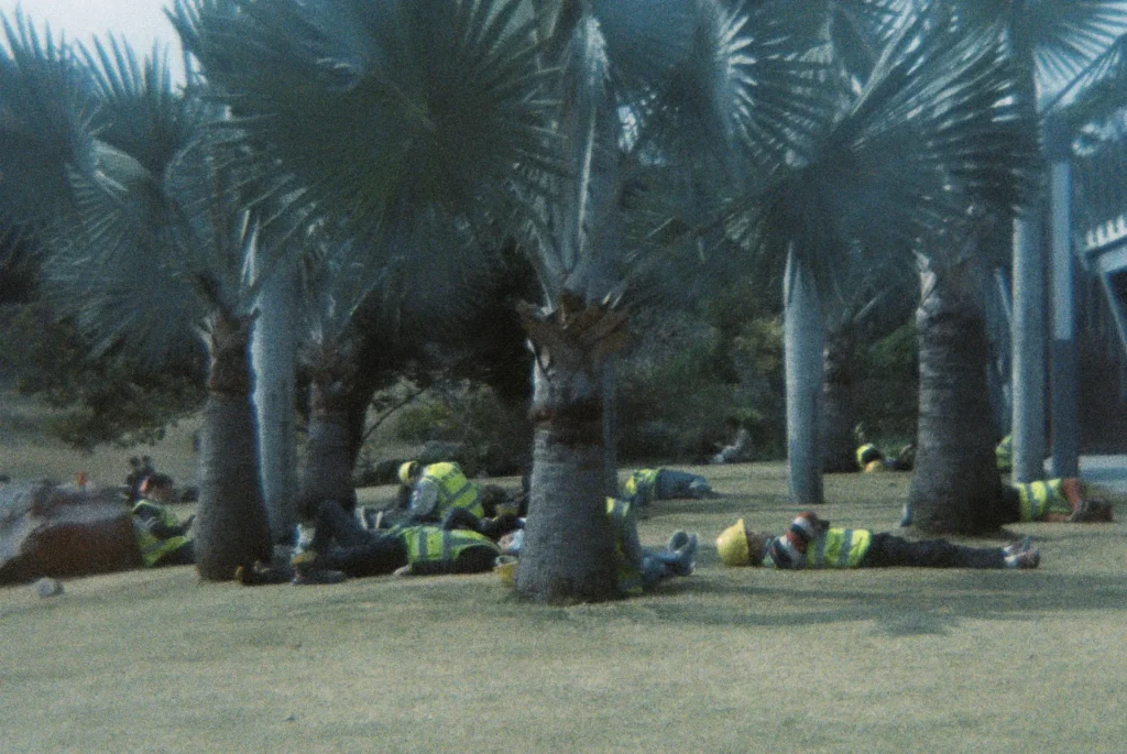 Workers resting in shadows during lunch break