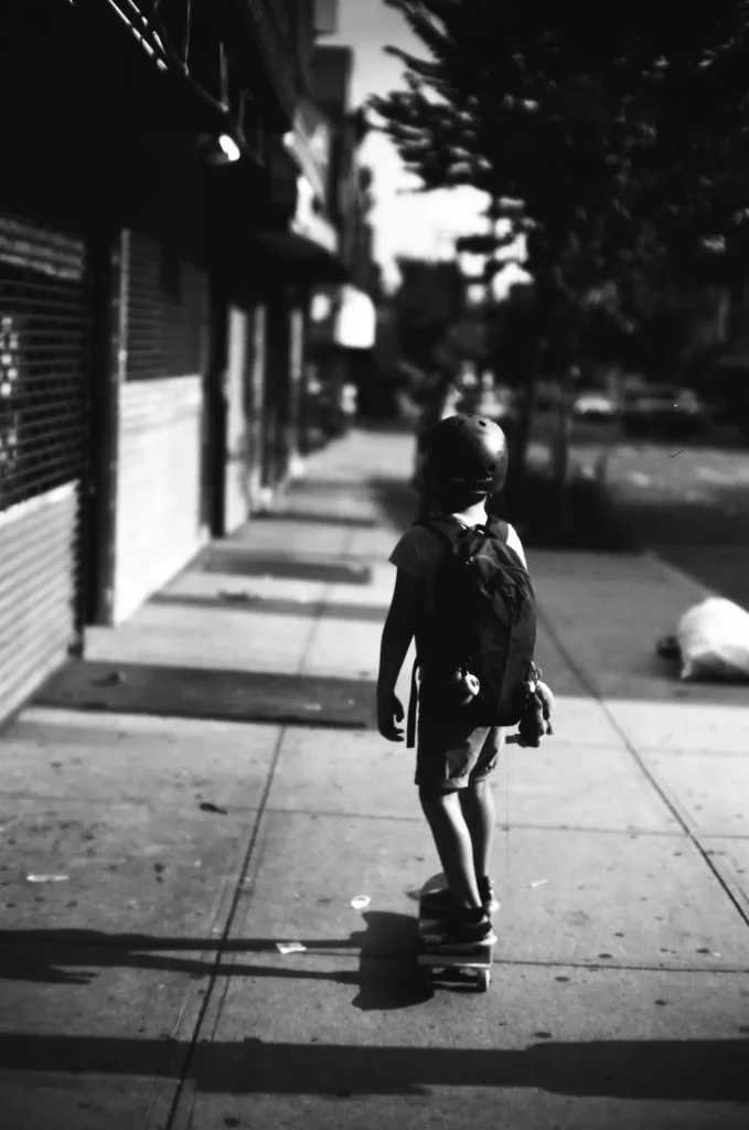 My son returning home on his skateboard.