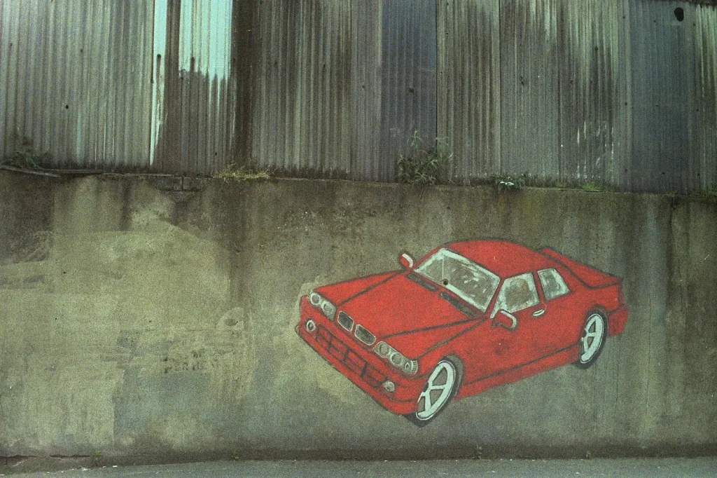 photo of a red car painted on a wall