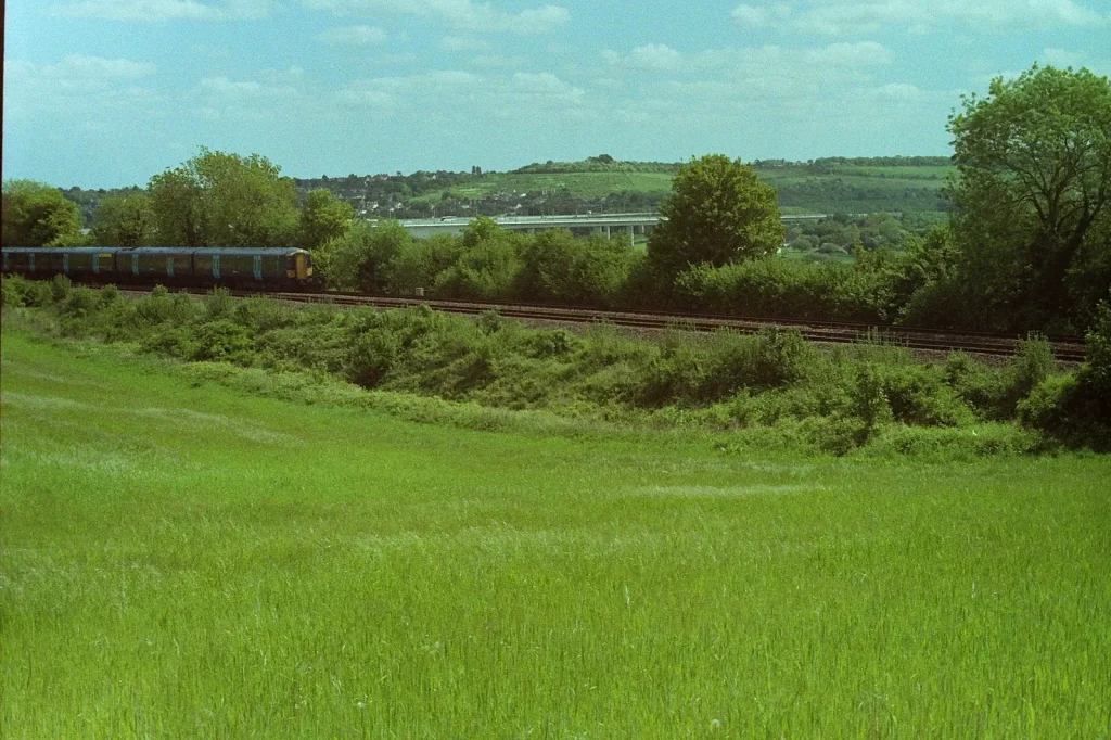 a photograph of a train whizzing through the countryside