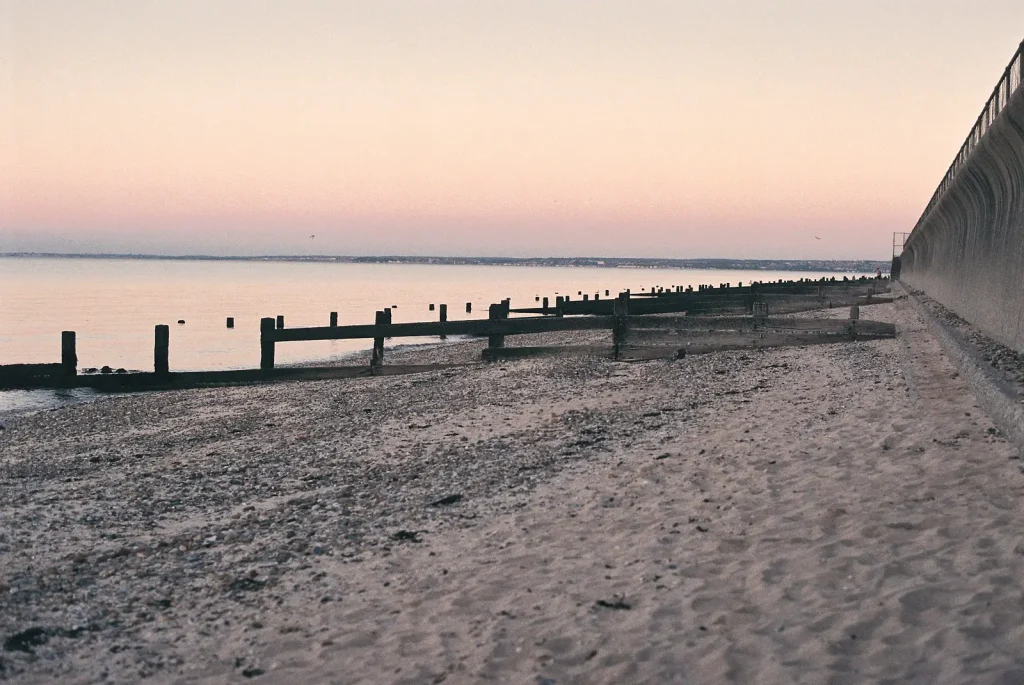 photograph of beach groynes as sun sets