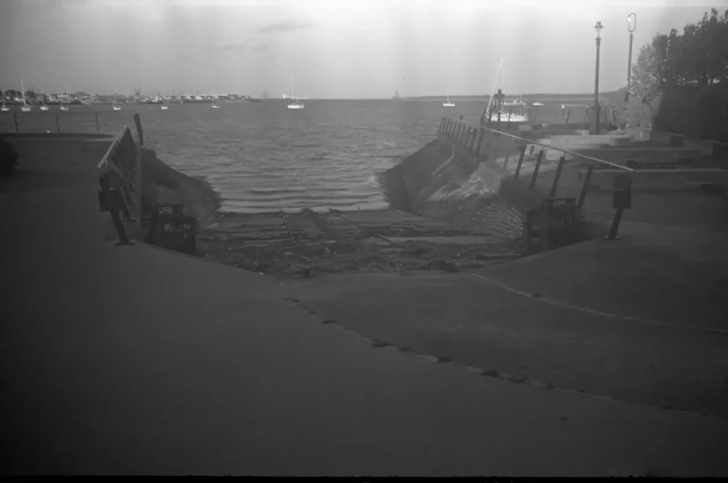 monochrome photograph with slipway to sea