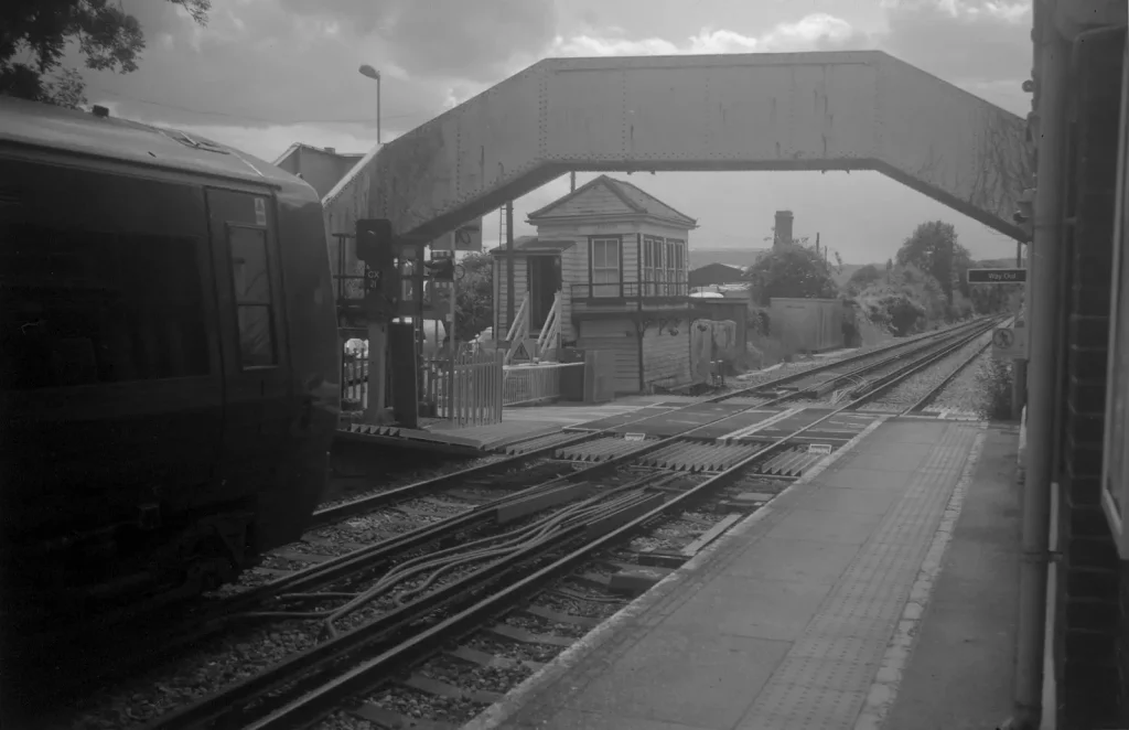 monochrome photo of train at a station
