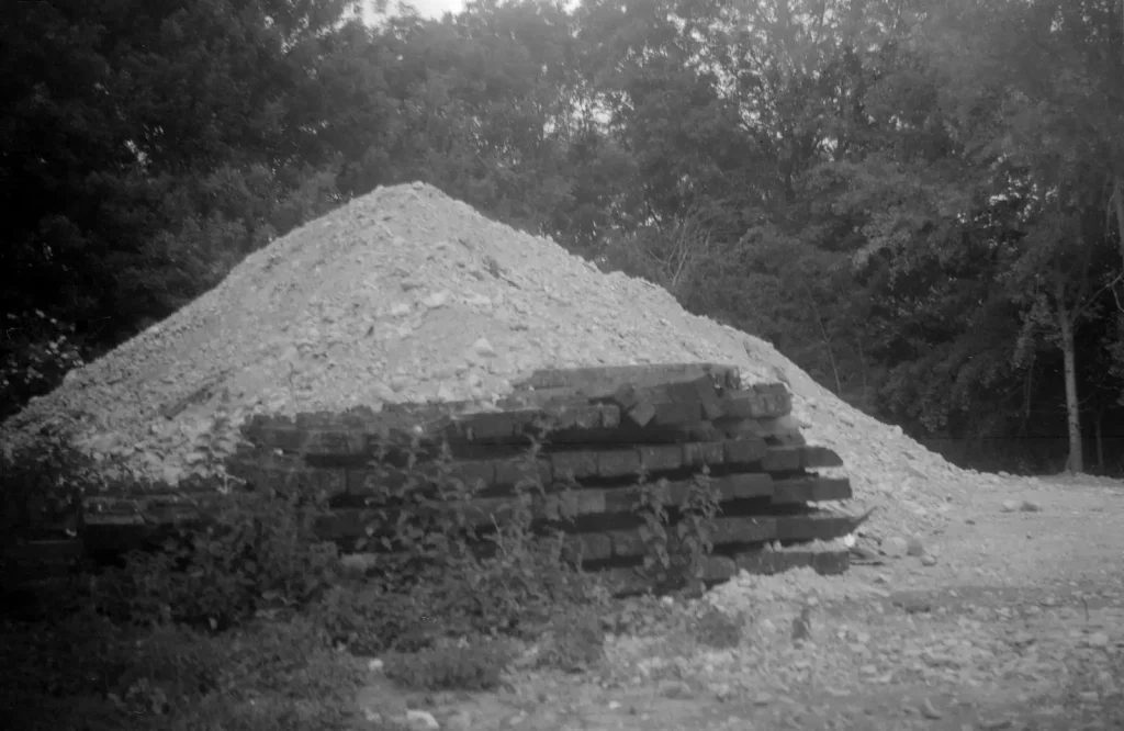 monochrome photograph of old railway sleepers and earth