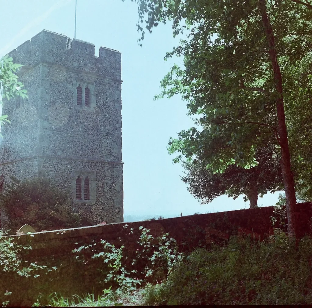 photo of church tower behind wall