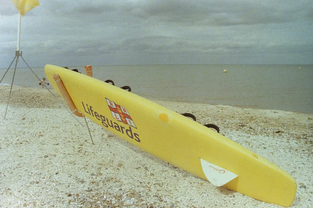 a photograph of a lifeguard board on a beach