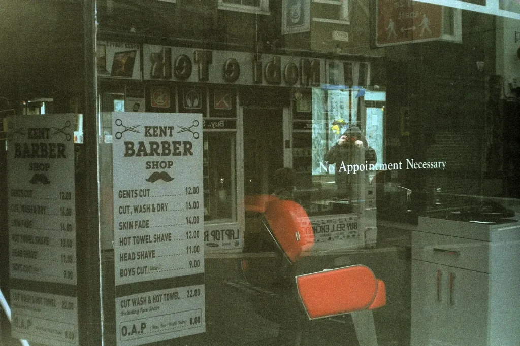 photo showing reflection in a barber shop window