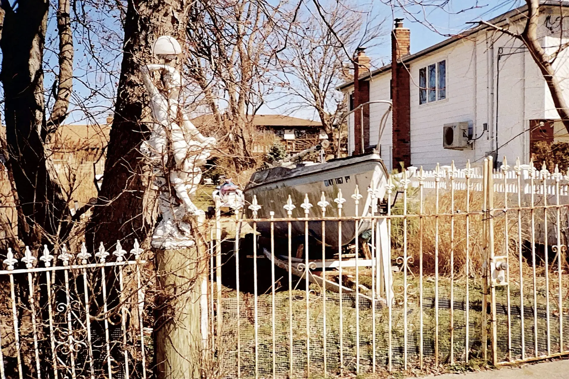 Untitled picture of a statue, boat and fence