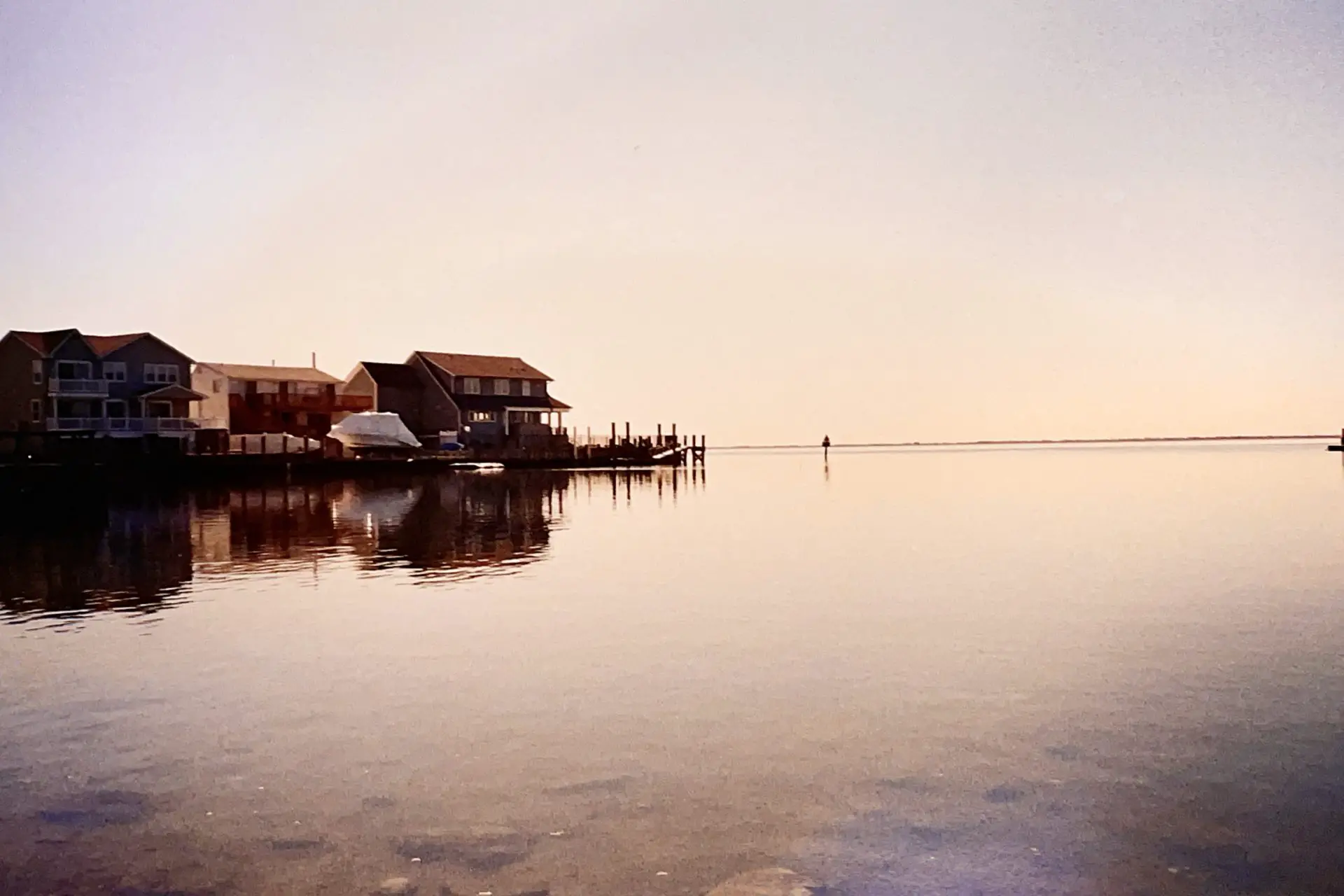 Tranquil, waterfront homes against the distant horizon