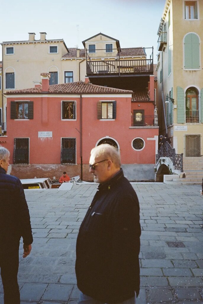 random man walking in front of me as I shoot a street landscape